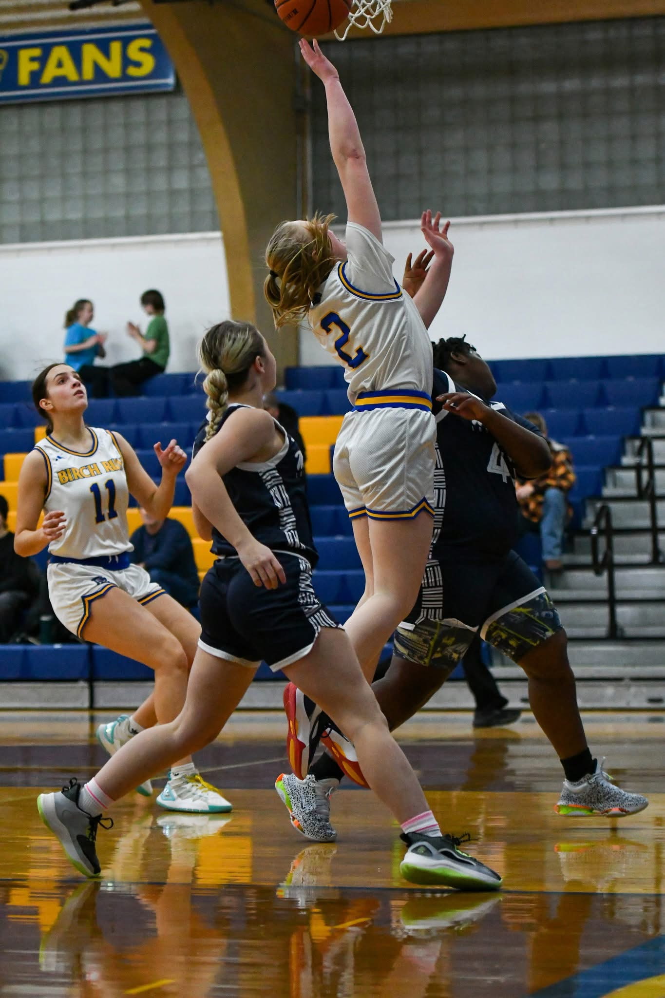 Jeahna Schmidt finishing a layup through contact